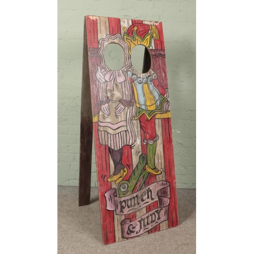 397 - A vintage wooden fairground 'Aunt Sally' peep board depicting Punch & Judy. 151cm x 59cm.