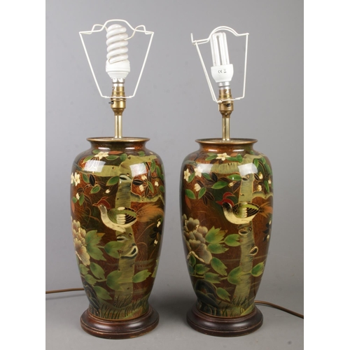 407 - A pair of large pottery table lamps, hand painted with birds and flowers. Height 38cm.