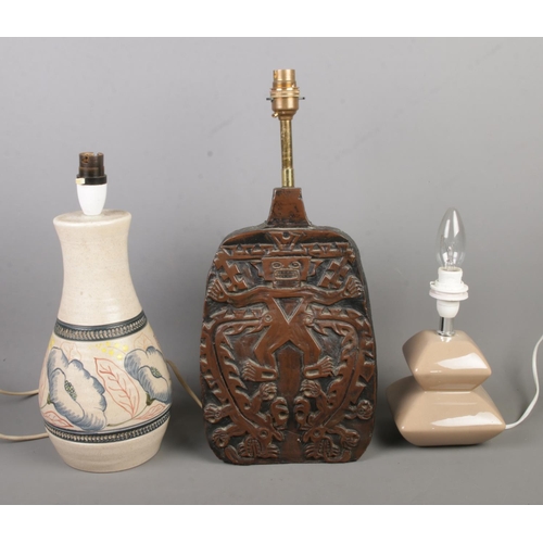 439 - Three lamps to include Purbeck Pottery and carved examples.