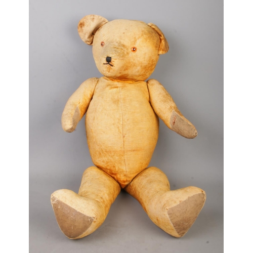 447 - A large vintage jointed bear. Length 73cm.