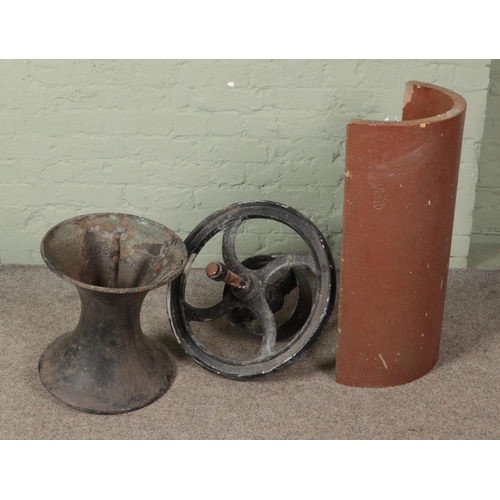 463 - A cast iron diablo style pot together with cast iron wheel and half drainage pipe marked J Kitson an... 