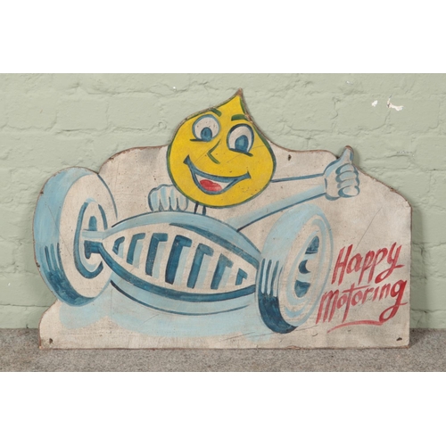 480 - A vintage painted wooden board advertising Esso, 'Happy Motoring'. 60cm x 86cm.