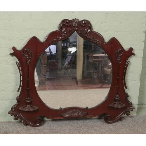 491 - A large carved mahogany over mantel mirror. 104cm x 129cm.