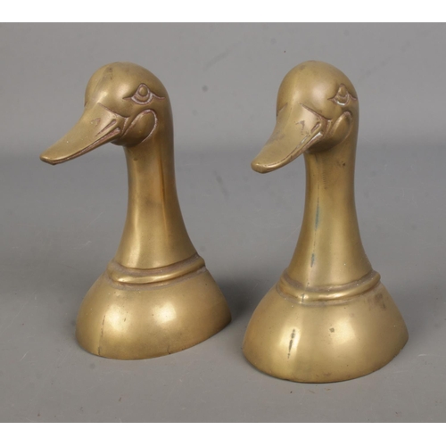 68 - Two novelty brass bookends formed as duck busts.