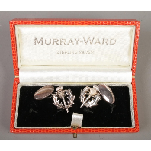 539 - A pair of cased Murray Ward silver thistle cufflinks. Stamped 925 with maker's initials.