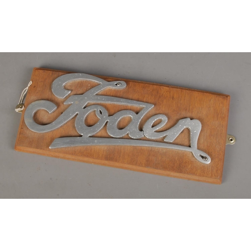 76 - A metal Foden lorry sign mounted on wooden plaque. Approx. size 36cm x 16cm.