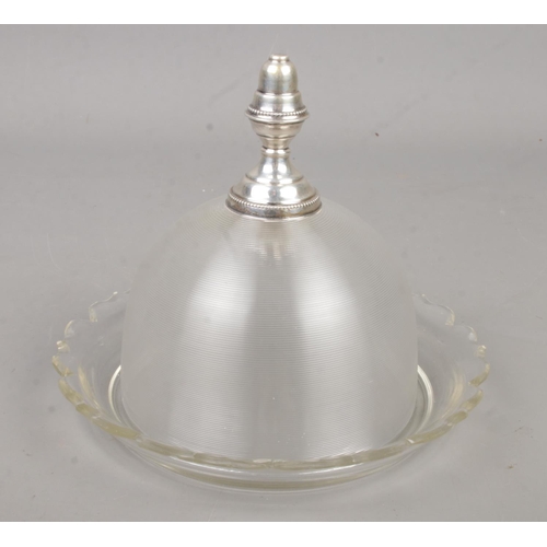 574 - A 19th century glass butter dish with domed top and silver finial/handle. Handle bearing Dutch sword... 