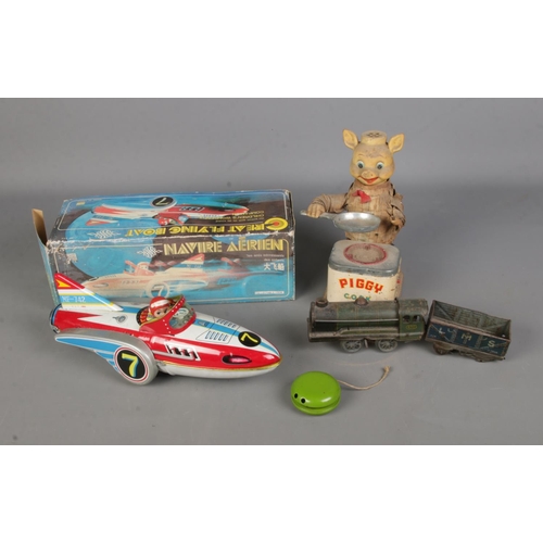 95 - A collection of vintage tin plate toys to include boxed Great Flying Boat, battery operated Piggy Co... 