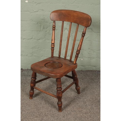 586 - An early 20th century elm and ash child's potty chair