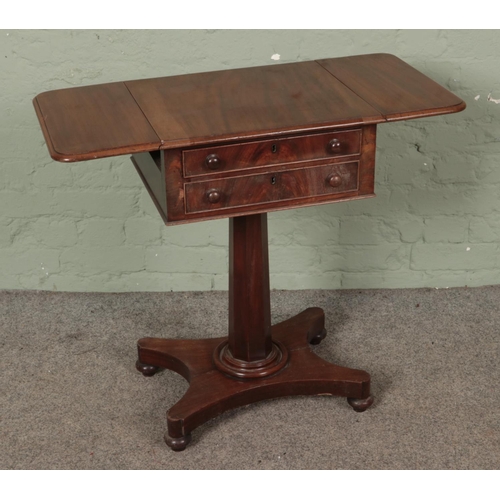 587 - Regency mahogany teapoy having two facing drawers and supported on a pedestal quatraform base.

Hx74... 