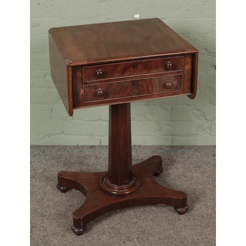 587 - Regency mahogany teapoy having two facing drawers and supported on a pedestal quatraform base.

Hx74... 