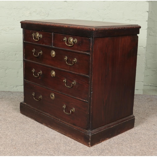 595 - A carved oak and pine two over three chest of drawers of small proportions. (77cm x 79cm x 47cm)