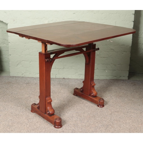 597 - A Victorian mahogany drop leaf rise and fall buffet table.