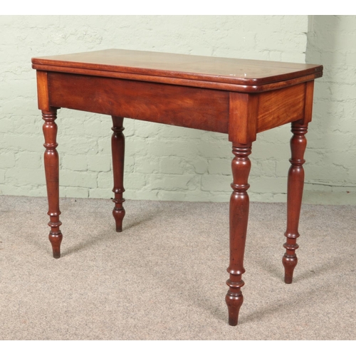 598 - A Victorian mahogany fold over table.