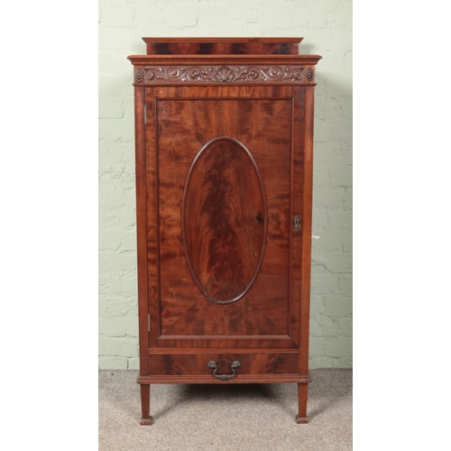 600 - A carved mahogany cabinet with drawer base. (131cm x 60cm x 44cm)