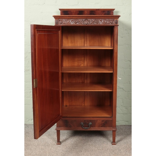 600 - A carved mahogany cabinet with drawer base. (131cm x 60cm x 44cm)