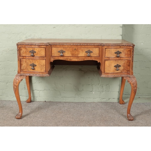 601 - A Queen Anne style carved walnut desk/dressing table. (78cm x 116cm x 55cm)