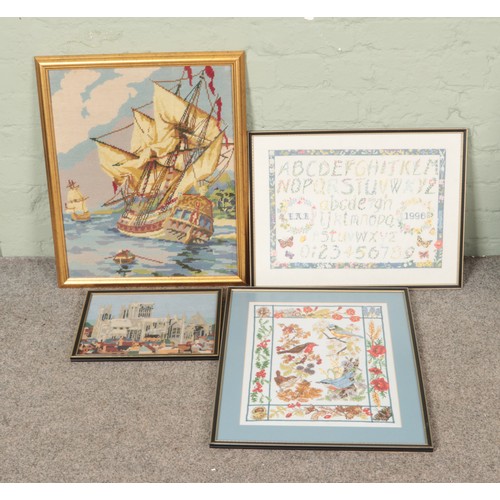 528 - Four framed embroideries to include tapestry and cross stitch examples with subjects including birds... 