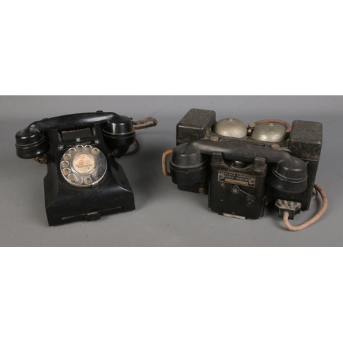 107 - A British Telephone Set 'F' MKII TMC field telephone, together with a black vintage rotary dial tele... 