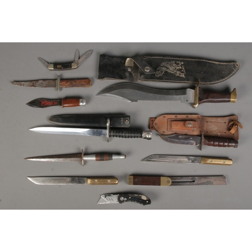 124 - A quantity of knives. Includes bowie knife, throwing knife, pocket knife, etc. CANNOT POST OVERSEAS.