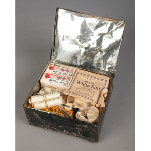 138 - A tin plate Dinghy First Aid Outfit box, with contents. Includes dressing, iodine ampoule and white ... 