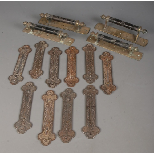 139 - A set of ten metal plates, previously used as handles, together with two sets of two pull handles.