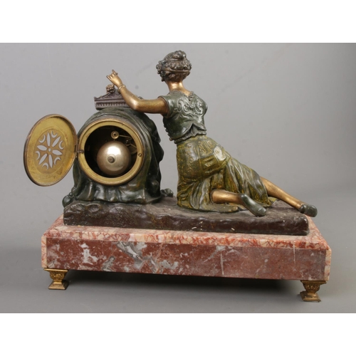 155 - A French figural mantel clock surmounted with a spelter maiden. Raised on marble base and bearing la... 