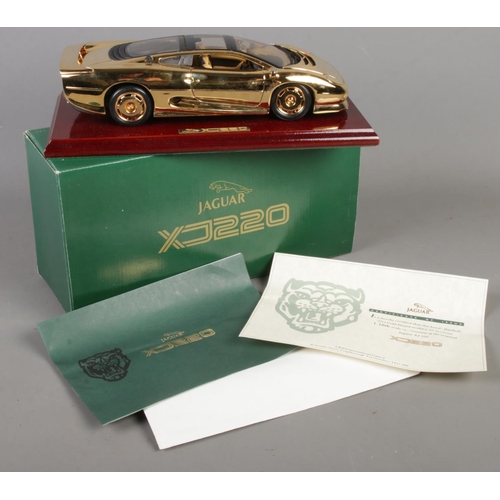 166 - A boxed Gwilo 1/18th scale 22ct gold plated Jaguar XJ220.