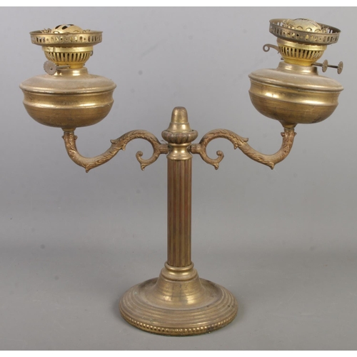 172 - A late 19th/early 20th century brass twin light oil lamp.