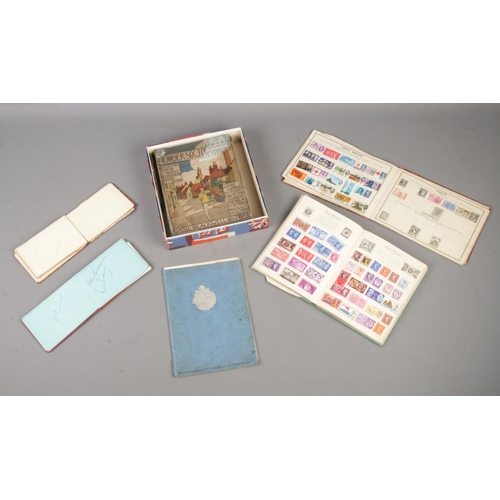 200 - A collection of assorted ephemera, to include two partially filled stamp albums, autograph books fea... 