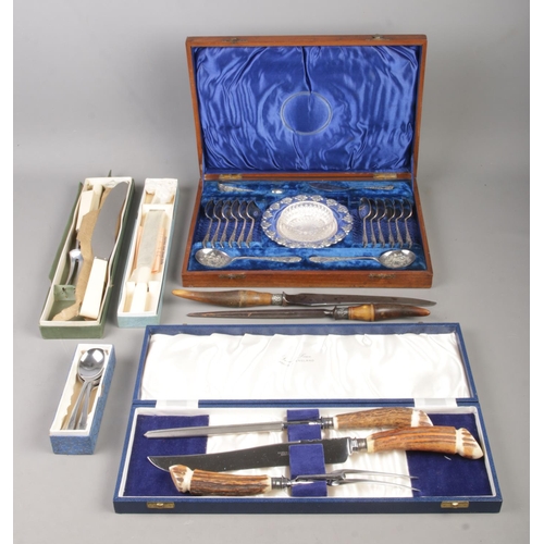 216 - A collection of mainly boxed flatware, to include Victorian horn handled carving set and James Dixon... 