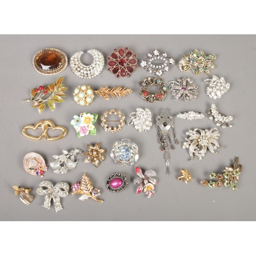 248 - Thirty costume jewellery brooches, including marcasite, large statement and floral examples.