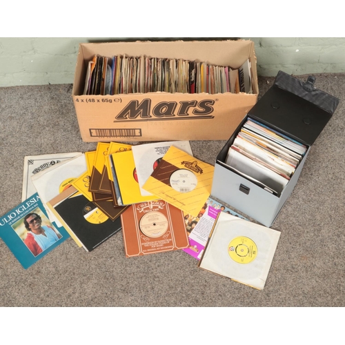 326 - A box of single records. Includes John Lennon Watching The Wheels, David Bowie China Girl, Boney M S... 