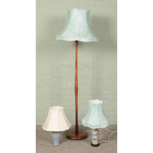 423 - A wooden turned standard lamp, together with two ceramic table lamps.