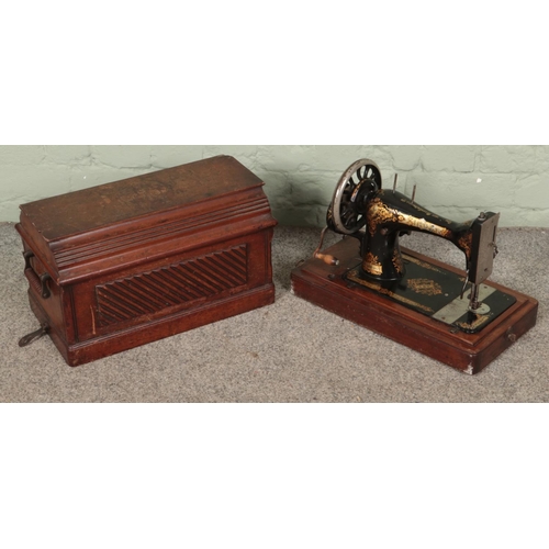 437 - A oak cased Singer sewing machine.