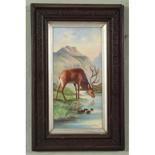 475 - A. Williams framed porcelain tile. Depicting a stag drinking from a lake. (29cm x 15cm)