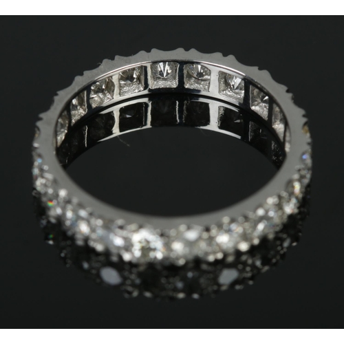 551 - A platinum and diamond eternity ring, containing twenty-one stones, all sized approximately 1/16ct. ... 