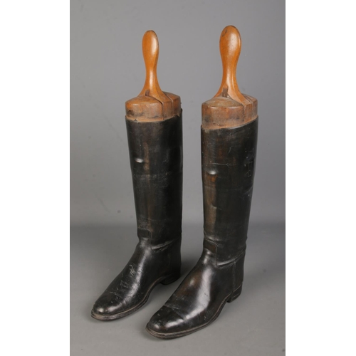 82 - A pair of vintage black leather riding boots, with large wooden three-section boot trees, marked L a... 