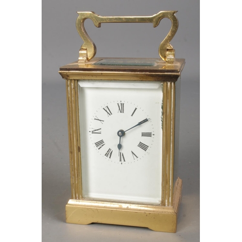 560 - A small brass carriage clock. With open top bevelled glass escapement. (13cm)