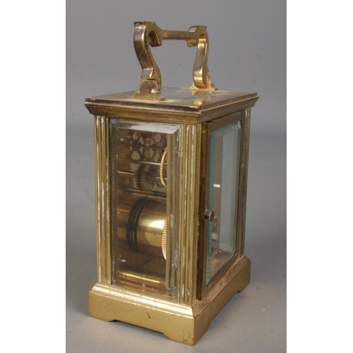 560 - A small brass carriage clock. With open top bevelled glass escapement. (13cm)