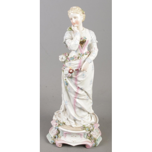 566 - A Meissen figure formed as a maiden holding a hand fan. (35cm)