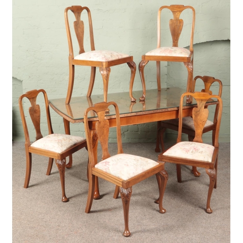 604 - A carved walnut extending dining table with six matching chairs with floral upholstery seats. Table ... 