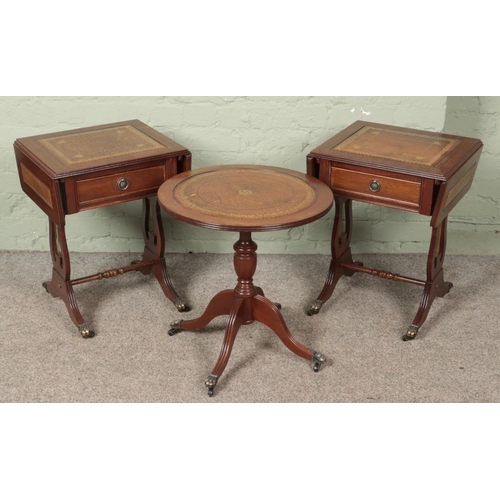 607 - A pair of mahogany sofa tables with lyre supports and leather inset tops along with a matching circu... 