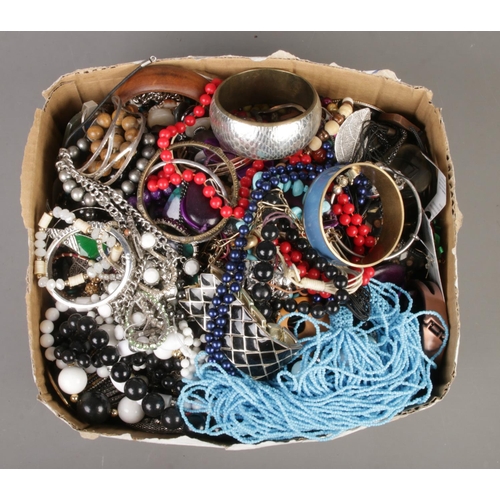 341 - A large box of costume jewellery, to include beaded necklaces, bangles, bracelets and earrings etc.