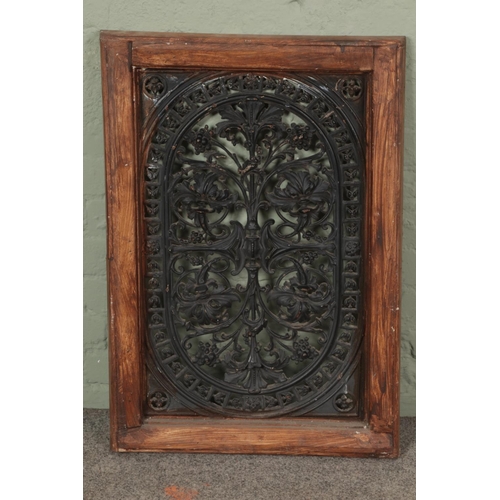 382 - A large pierced cast iron plaque/vent within a wooden mount. Height: 85cm, Width: 59cm.