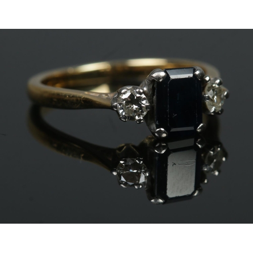 535 - An 18ct Gold and three stone diamond and sapphire ring. Size J. Total weight: 2.8g.