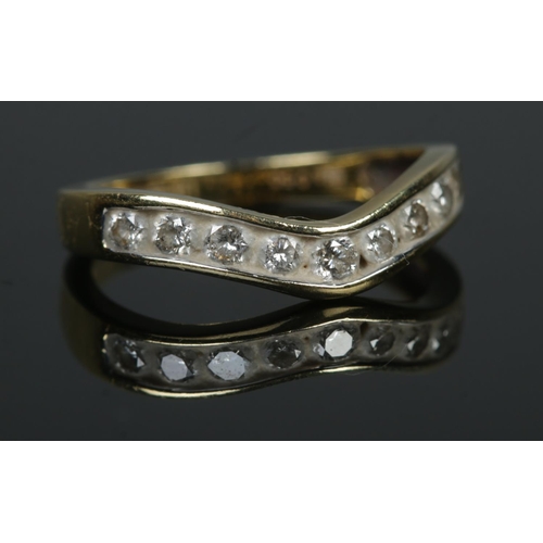 537 - An 18ct Gold and nine stone diamond wishbone ring. Total diamond: ½ct. Size L½. Total weight: 2.9g