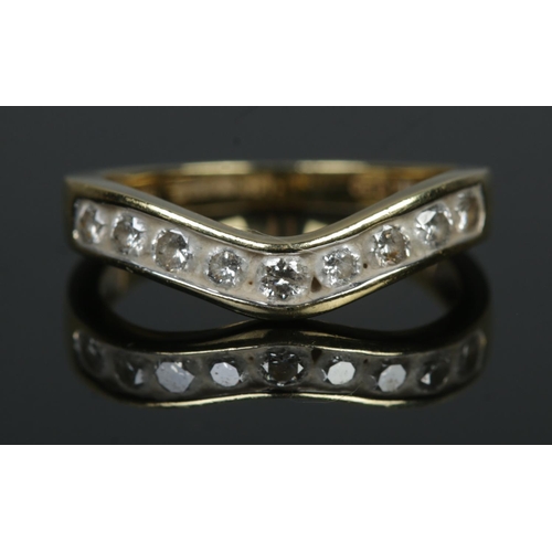 537 - An 18ct Gold and nine stone diamond wishbone ring. Total diamond: ½ct. Size L½. Total weight: 2.9g