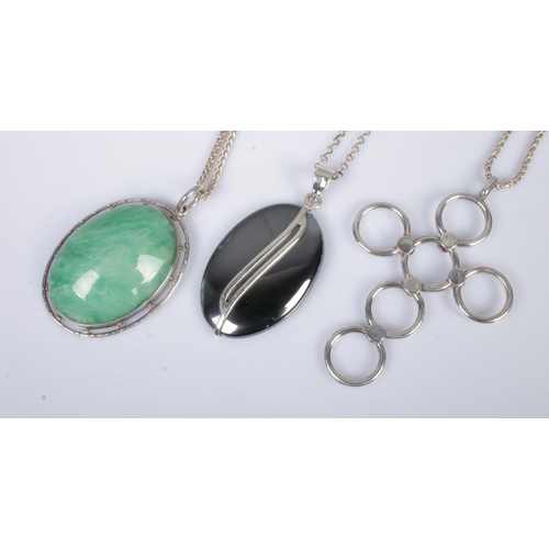 550 - Three silver mounted and silver pendants, on silver necklace chains. Total weight: 46.8g