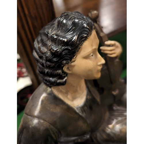 109 - A large Art Nouveau style slate figural mantel clock. Formed as a seated maiden holding a violin. (3... 